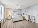 Main bedroom featuring plank flooring, light gray walls, and ceiling fan at 530 Valencia Pl, The Villages, FL 32159
