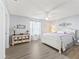 Comfortable main bedroom with light gray walls, ceiling fan, and plank flooring at 530 Valencia Pl, The Villages, FL 32159