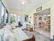 Bright sunroom featuring tile floors, lots of windows, and view to dining area at 530 Valencia Pl, The Villages, FL 32159