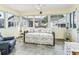 Comfortable sunroom with a daybed, tile flooring, and lots of natural light at 530 Valencia Pl, The Villages, FL 32159