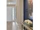 Bright entryway with a chandelier, complemented by stylish decor and modern finishes at 5675 Nickerbean St, Apopka, FL 32712