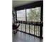 Enclosed balcony providing natural light and offering views of the surrounding trees at 601 N Mcdonald St # 408, Mount Dora, FL 32757