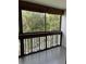 Enclosed balcony with views of lush trees and the neighborhood below at 601 N Mcdonald St # 408, Mount Dora, FL 32757