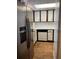 Kitchen with stainless steel fridge and white cabinets, ample natural light at 601 N Mcdonald St # 408, Mount Dora, FL 32757
