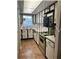 Efficient kitchen features ample white cabinets and stainless steel appliances at 601 N Mcdonald St # 408, Mount Dora, FL 32757