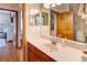 Bathroom features a wood door, sink with a wood cabinet, and an interior door leading to the bedroom at 605 Westview Dr, Minneola, FL 34715