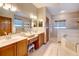 Primary bathroom with double sinks, vanity area, and a separate shower and soaking tub at 605 Westview Dr, Minneola, FL 34715