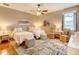 Inviting bedroom with two beds, vibrant rug, and natural light at 605 Westview Dr, Minneola, FL 34715