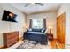 Comfortable bedroom with a window, TV, dresser, and wood accents at 605 Westview Dr, Minneola, FL 34715