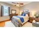 Stylish bedroom with a ceiling fan, neutral tones, and decorative pillows on the bed at 605 Westview Dr, Minneola, FL 34715