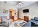 Modern bedroom with a mounted TV, adjacent bathroom, and wood flooring at 605 Westview Dr, Minneola, FL 34715