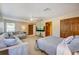 Spacious bedroom with cozy sitting area, ceiling fan, and wood doors at 605 Westview Dr, Minneola, FL 34715