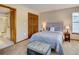 Comfortable bedroom with plush bed, ensuite bathroom, and soft lighting at 605 Westview Dr, Minneola, FL 34715