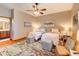 Charming bedroom with two beds, colorful rug, and decorative artwork at 605 Westview Dr, Minneola, FL 34715