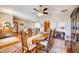 Open-concept dining area with hardwood floors, a ceiling fan, and views into the living spaces at 605 Westview Dr, Minneola, FL 34715