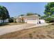 Attractive home with a spacious driveway, well-maintained lawn, and attached two-car garage at 605 Westview Dr, Minneola, FL 34715