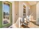 Inviting front porch with decorative chairs and a stylish glass-paneled front door at 605 Westview Dr, Minneola, FL 34715