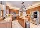 Well-equipped kitchen with stainless steel appliances, wooden cabinets, and a functional center island at 605 Westview Dr, Minneola, FL 34715