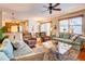 Cozy living room with hardwood floors, comfortable seating, and a ceiling fan at 605 Westview Dr, Minneola, FL 34715