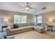 Bright living room featuring a large sectional sofa and natural light from the windows at 605 Westview Dr, Minneola, FL 34715