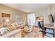 Inviting living room with comfortable seating, natural light, and a dedicated workspace at 605 Westview Dr, Minneola, FL 34715