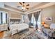 Relaxing main bedroom with tray ceilings, hardwood floors, and access to the outdoor pool area at 605 Westview Dr, Minneola, FL 34715