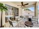 Covered patio with ceiling fan and outdoor seating area with a fire pit at 605 Westview Dr, Minneola, FL 34715