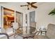 Covered patio with ceiling fan and outdoor seating; kitchen and dining room are visible through sliding glass doors at 605 Westview Dr, Minneola, FL 34715