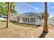 This in-ground pool features an attached jacuzzi. Palm trees surround the screen, providing shade to the backyard at 605 Westview Dr, Minneola, FL 34715