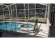 A safety net surrounds the pool and jacuzzi in this backyard pool, providing safety for children at 605 Westview Dr, Minneola, FL 34715
