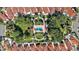 Perfectly planned community with pool and gathering area in the middle of homes with mature shade trees at 623 Delgado Ave, The Villages, FL 32159