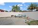 Outdoor patio with garden featuring seating area, landscaping and mature palm trees at 623 Delgado Ave, The Villages, FL 32159