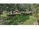 Scenic community pool area surrounded by trees and lush lawn offering a relaxing retreat at 623 Delgado Ave, The Villages, FL 32159