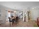 Cozy dining area with wood flooring, stylish light fixture, and easy access to both the kitchen and outdoor space at 623 Delgado Ave, The Villages, FL 32159