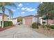 Charming single-story home with landscaped front yard, driveway, and a two-car garage in a well-maintained neighborhood at 623 Delgado Ave, The Villages, FL 32159