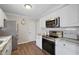 Well-lit kitchen featuring stainless steel appliances, white cabinets, and granite countertops, perfect for cooking and entertaining at 623 Delgado Ave, The Villages, FL 32159
