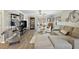 Comfortable living room with a neutral palette, plush seating, wood flooring, and plenty of natural light at 623 Delgado Ave, The Villages, FL 32159