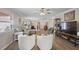 Bright and airy living room with ample seating, modern decor, and a seamless flow to the dining and kitchen areas at 623 Delgado Ave, The Villages, FL 32159