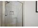 Modern shower with gray marble look tile, glass enclosure, and recessed storage niche at 623 Delgado Ave, The Villages, FL 32159