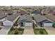 Aerial view showcasing the property's well-maintained landscaping, two-car garage and screened in porch at 6248 Siverson Ter, The Villages, FL 32163