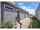 Home's back patio with a propane grill and a sliding glass door that leads indoors at 6248 Siverson Ter, The Villages, FL 32163