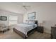 Relaxing bedroom with a plush bed, stylish lamps, a ceiling fan, and plenty of natural light at 6248 Siverson Ter, The Villages, FL 32163