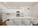 Stylish kitchen features a large marble island, stainless steel appliances, and white cabinetry at 6248 Siverson Ter, The Villages, FL 32163