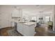 Open living space boasts a large kitchen island and flows into the dining and living rooms at 6248 Siverson Ter, The Villages, FL 32163