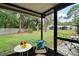 Back porch with a small table and chair looking out over a grassy yard at 638 Mount Homer Rd # 3-C, Eustis, FL 32726