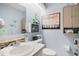Cozy half bath showcasing a sink, toilet, and unique, beach-themed wall decor at 638 Mount Homer Rd # 3-C, Eustis, FL 32726