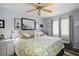 Comfortable bedroom featuring patterned bedding, neutral walls, and natural light from the windows at 638 Mount Homer Rd # 3-C, Eustis, FL 32726