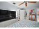 Bedroom with white built-in storage and a TV; open doorway leads to hallway at 638 Mount Homer Rd # 3-C, Eustis, FL 32726