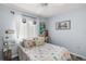 Bright bedroom with a colorful patterned bedspread and a window with sheer curtains at 638 Mount Homer Rd # 3-C, Eustis, FL 32726