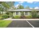 Charming home exterior with green siding, white shutters, landscaped bushes and well maintained yard and parking at 638 Mount Homer Rd # 3-C, Eustis, FL 32726